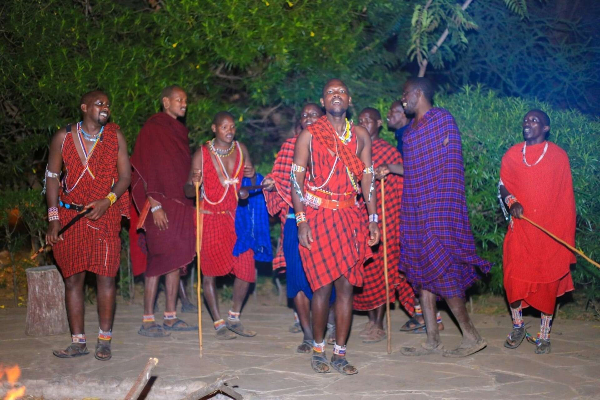 masai mara einwohner tanzen ums lagerfeuer